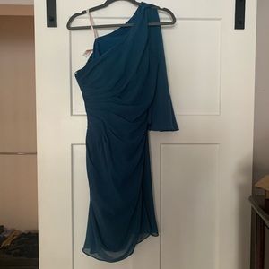 Teal, knee length dress with side embellishment.